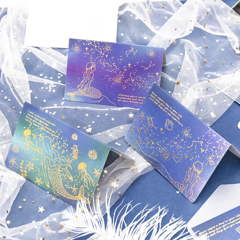 Set of three bronzing detail greeting card envelopes in cosmic colours, showing mermaid style fold.