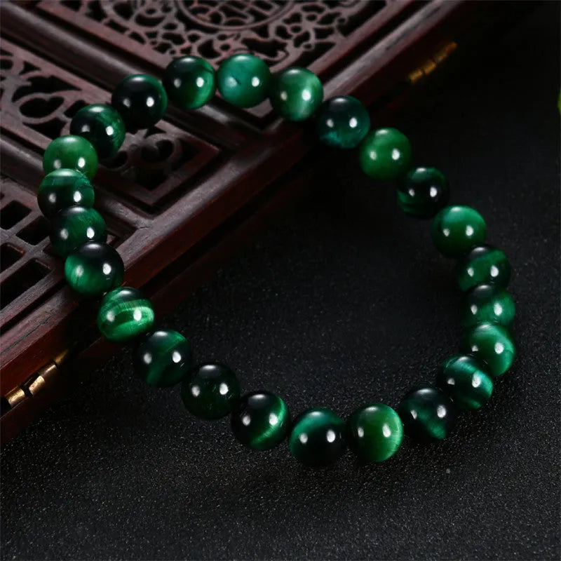 Green Tiger Eye stone bracelet with geometric beads, showing size options.