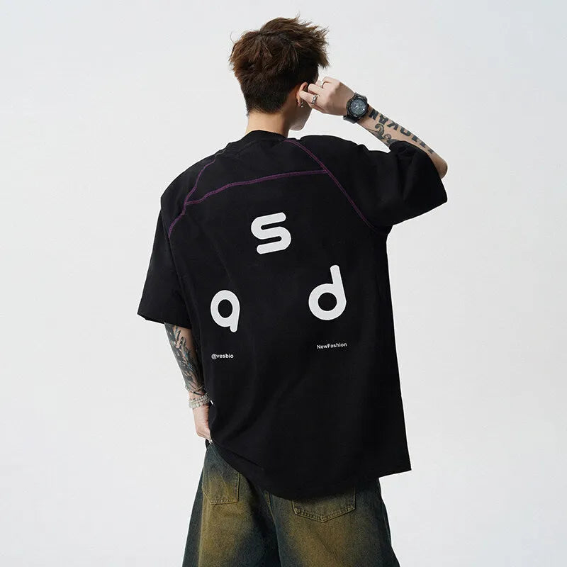 Black loose fit cotton T-shirt with white letter print on front, short sleeves and round neck.
