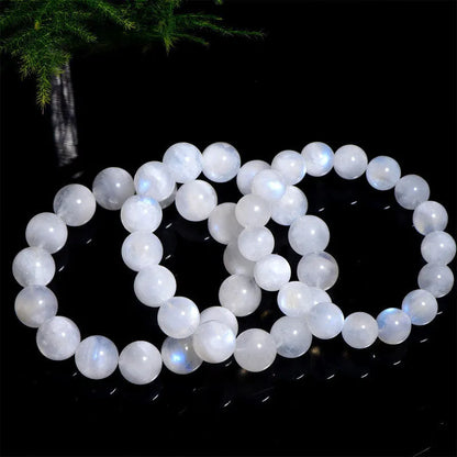 Natural blue moonlight round bead bracelet in white with polished moonstone beads showing blue sheen effect