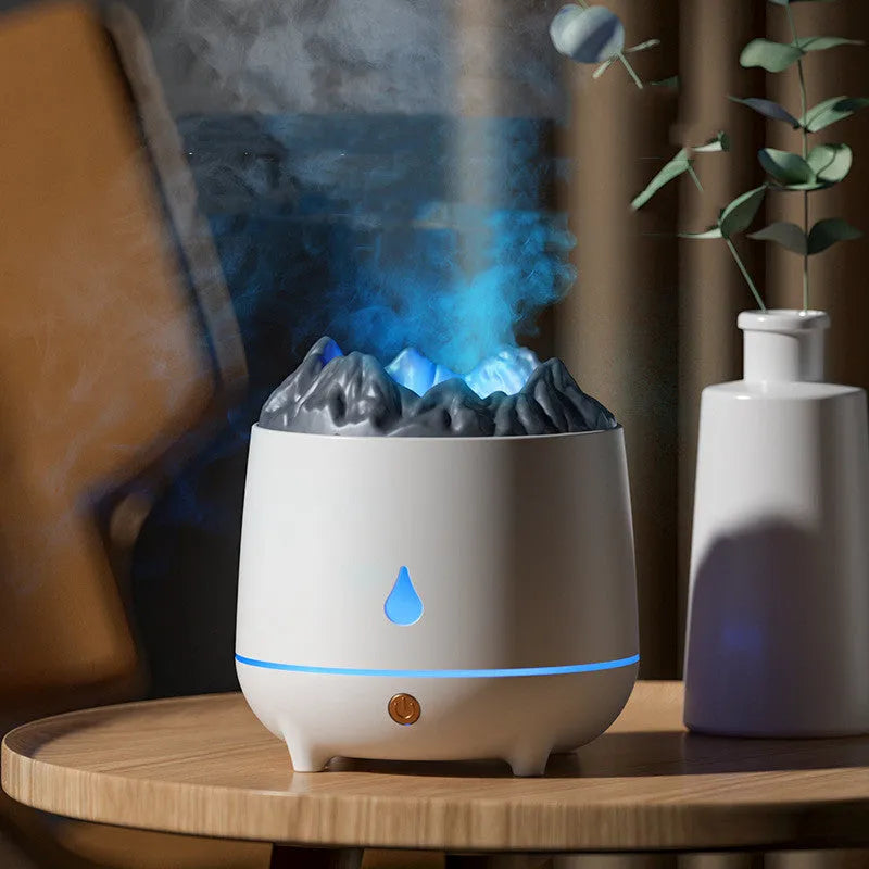 White volcano-shaped humidifier with USB cable on a wooden table, emitting mist.