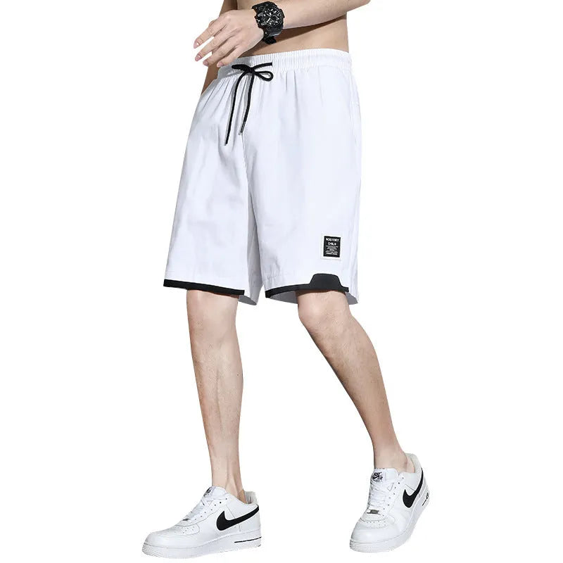 Cotton shorts for teenage boys in black, shown on a hanger, featuring a mid-waist design.