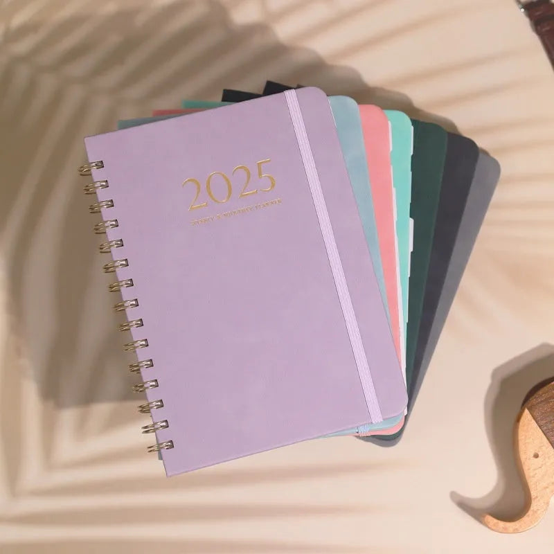 A5 size PU leather notebook with metal coil binding in a choice of colours including black, blue, and brown.