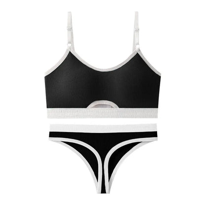 White sports bra and briefs set with thin moulded cups and double shoulder straps on a grey background.