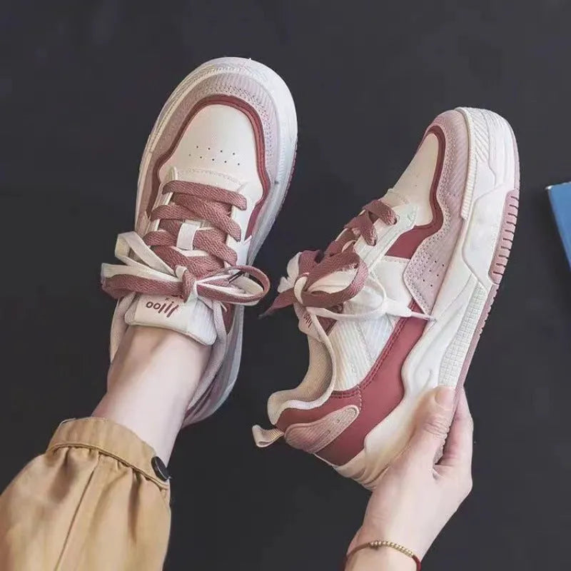 Women's beige and pink low-top sneakers with a rubber sole featuring hidden height increase.