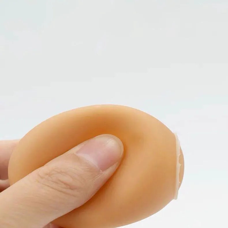 Pink rubber simulation egg dog toy with a textured surface for chewing.