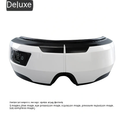 Black and white eye massager with USB cable, showing contoured design for eye socket placement