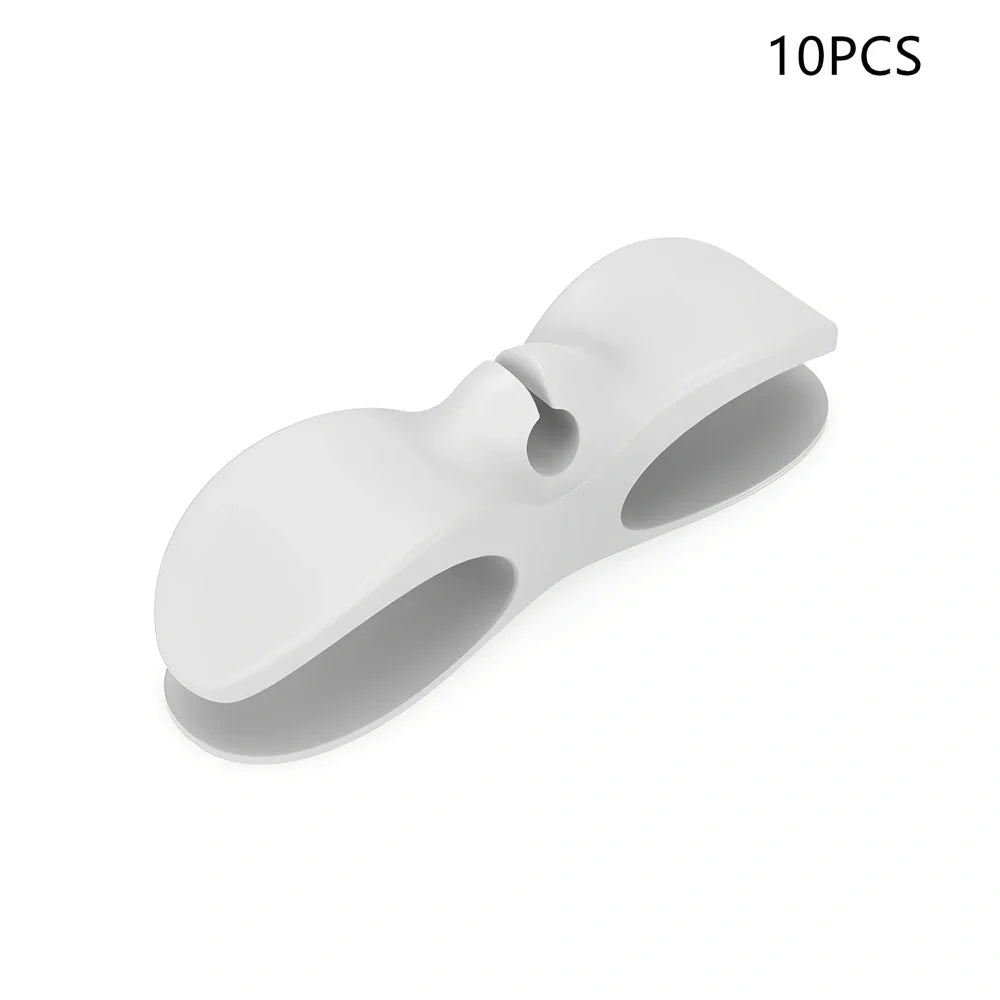 Black TPU cable organizer clips winding appliance cords on kitchen counter, 5cm size, non-marking adhesive for tidy management