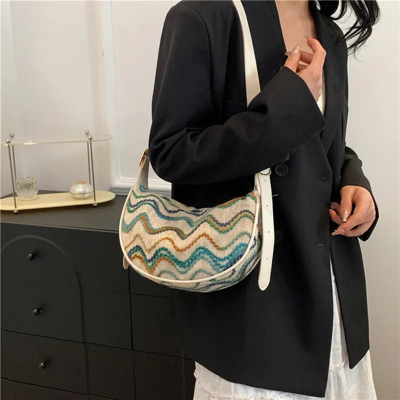Women's woven straw crossbody bag with internal phone and file pockets in various colours.