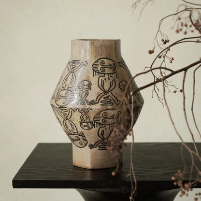 Hand-painted ceramic vase with religious patterns and carved texture in cylindrical shape