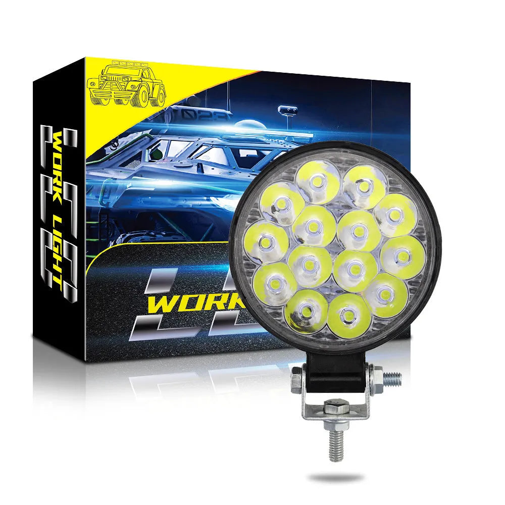 Small round white aluminium LED work light with IP67 rating for automotive use.
