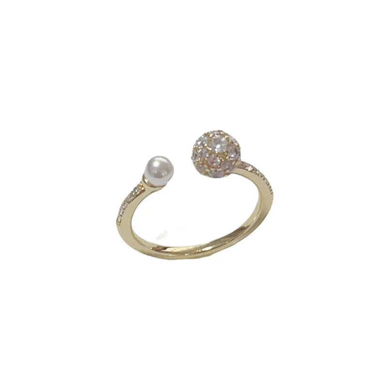 Open-end pearl ring with round zircon stones on geometric copper band with gold plating