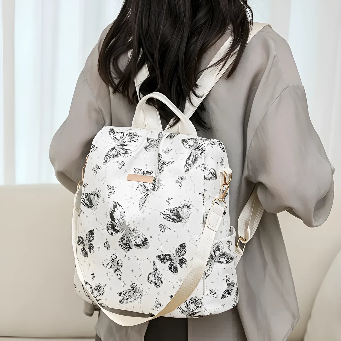 Butterfly printed large capacity PU backpack in various colours with sewing line details and an ergonomic back.
