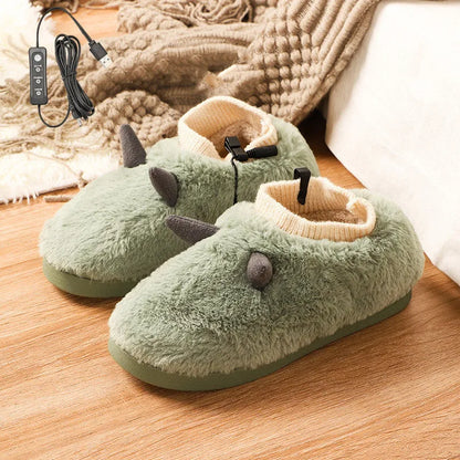 A pair of grey USB heated slippers with a connected cable, showing the soft velvet upper and plastic sole.