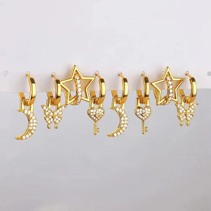Women's irregular geometric butterfly earrings in copper with diamond treatment, showing heart-shaped and star designs in various colours