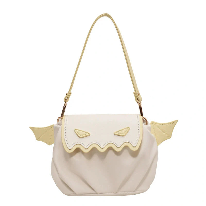 Halloween pumpkin cartoon crossbody bag with small wings in black, white, and orange