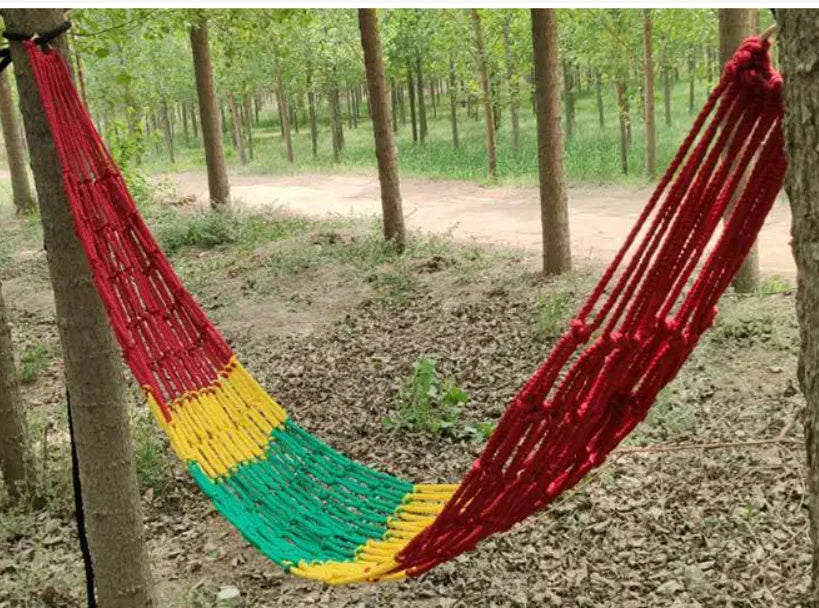Outdoor nylon rope mesh hammock with tying strap shown in use
