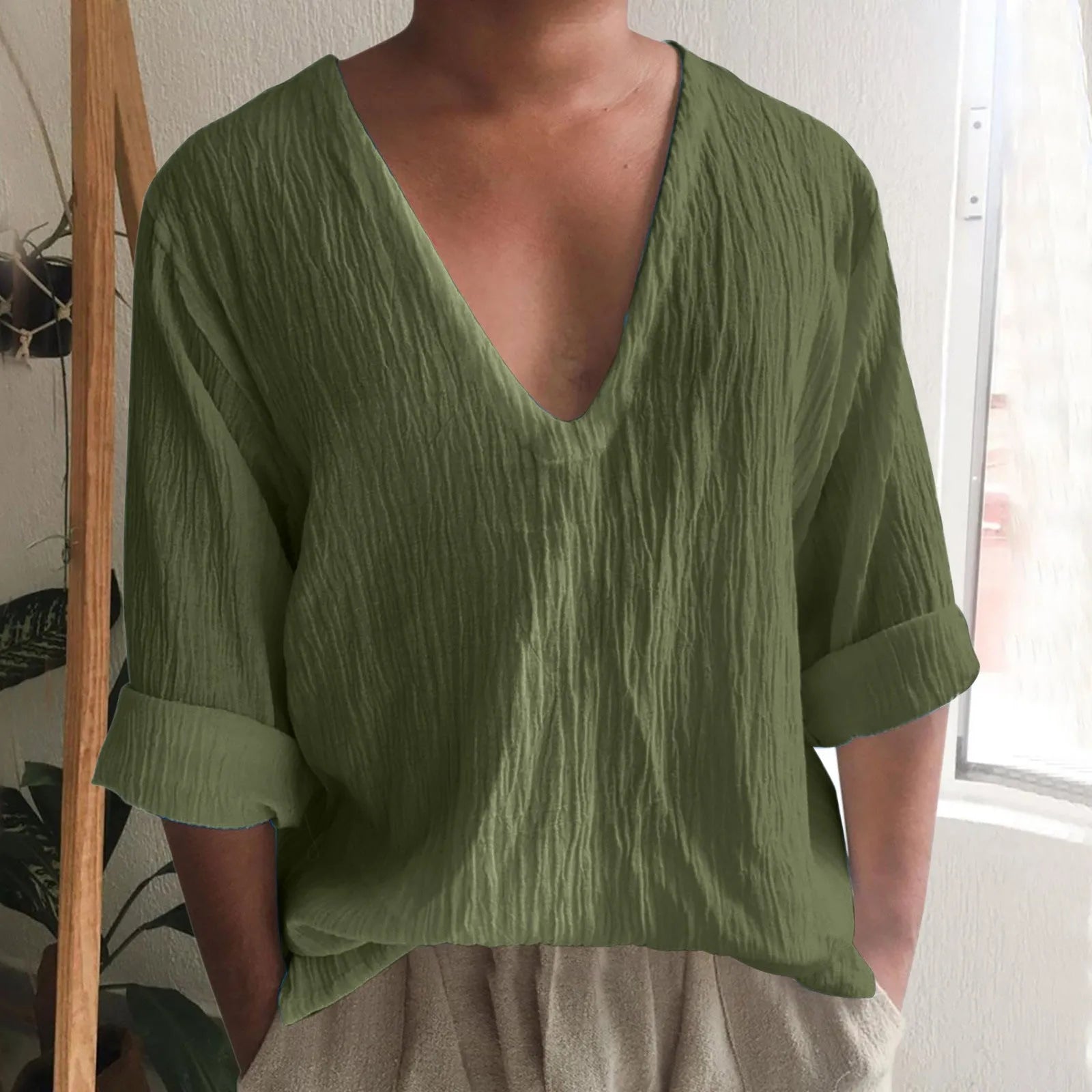 Men's washed cotton long sleeve V-neck t-shirt in a solid colour on a hanger.