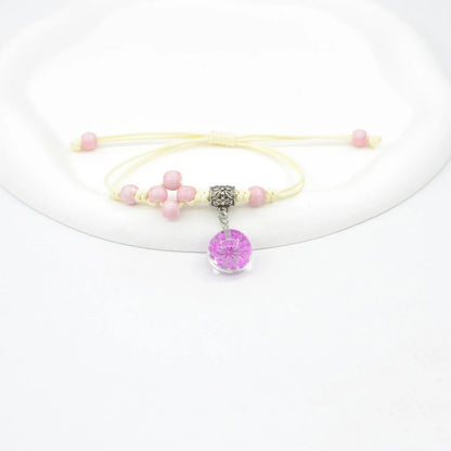 Hand-woven glass bracelet with large 1.4 cm beads containing real dried flowers, shown in blue.