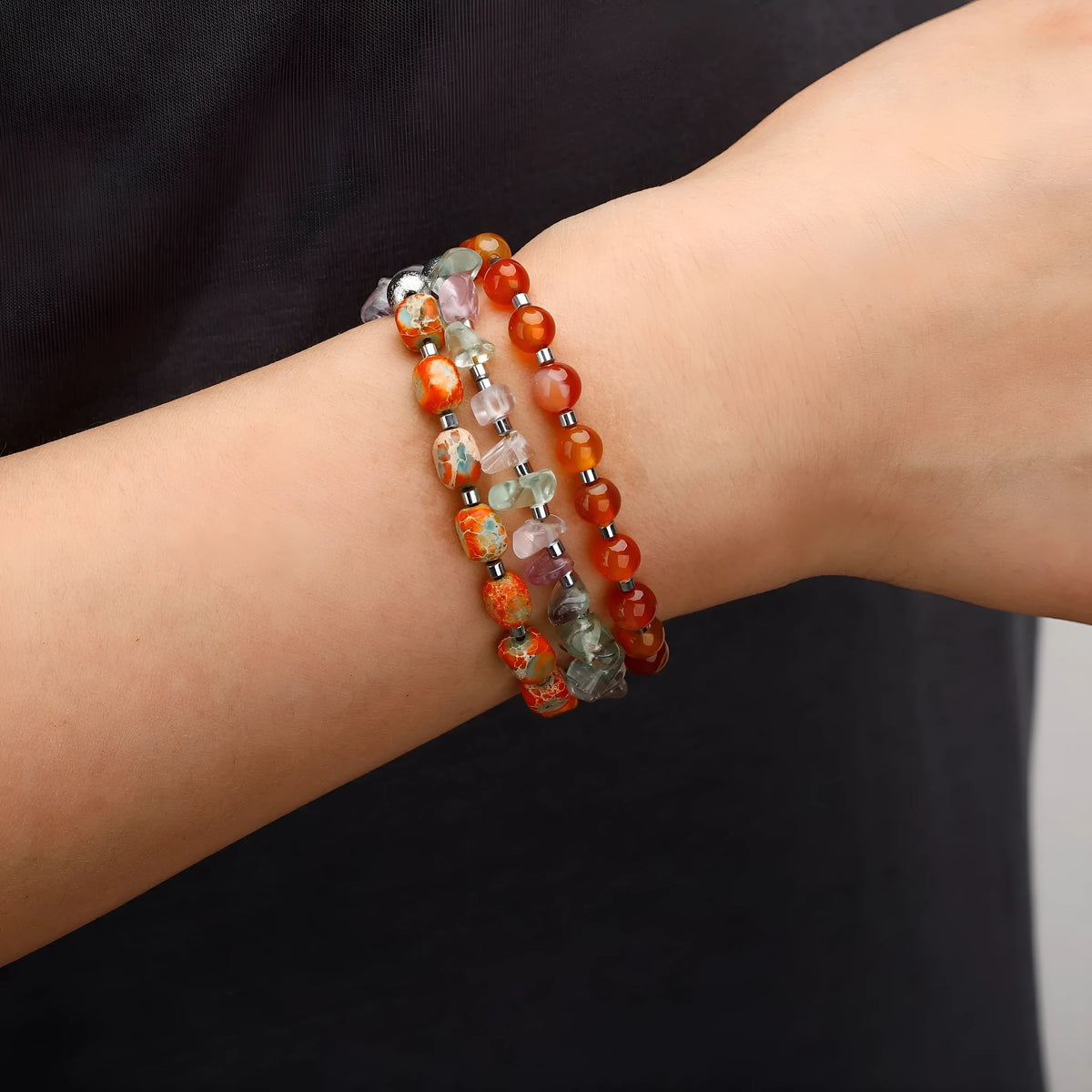Hand-woven red agate round beads bracelet with geometric shapes and textured surfaces
