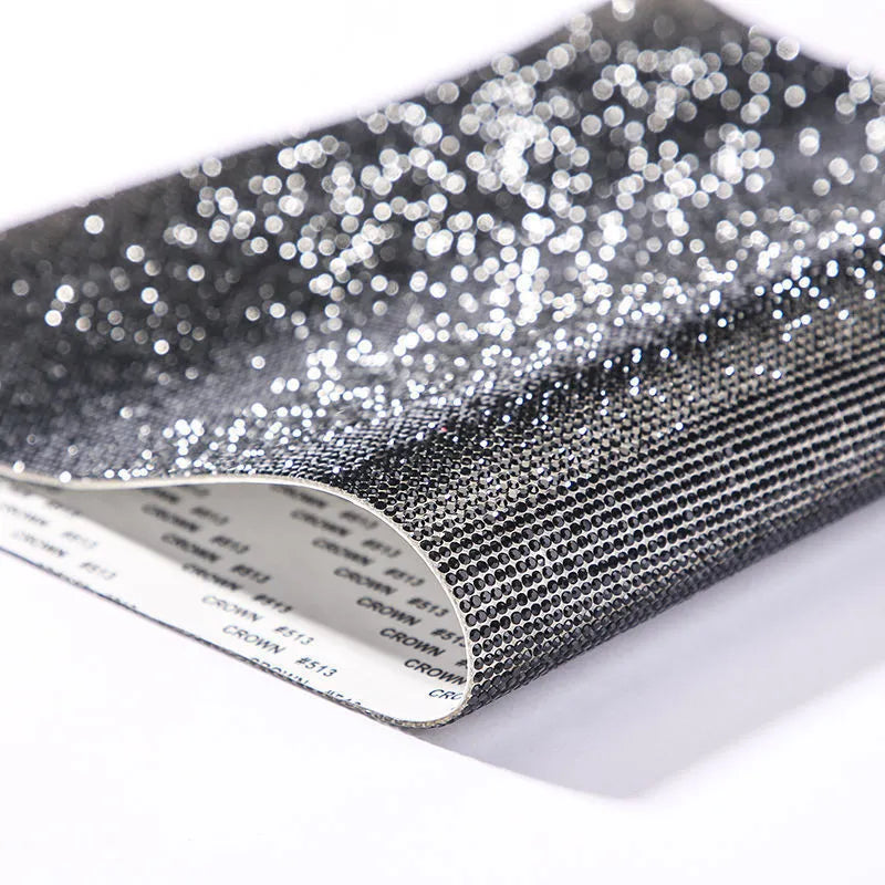 Rhinestone sticker net on backing sheet for hot drilling application to fabrics in multiple colour options