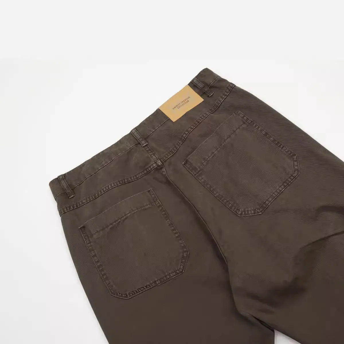 Men's brown loose straight leg cotton trousers with high waist and zipper fly