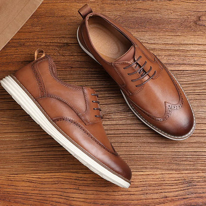 Men's black and brown slip-on business casual shoes with round toe and carved PU upper.