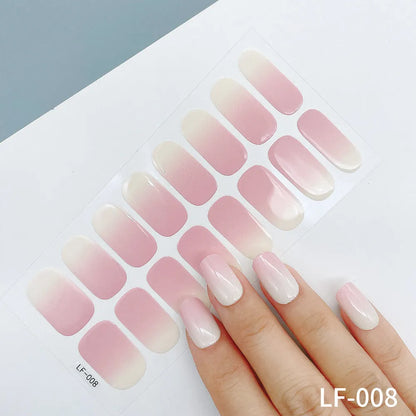 Sheet of 16 small design nail art stickers including cross, rose, tulip and marble patterns.