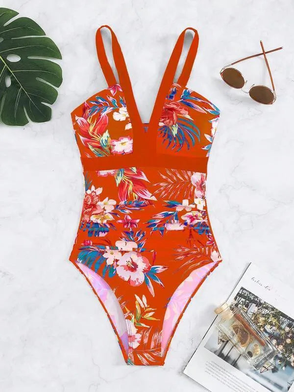 Women's floral pattern backless one-piece swimsuit on a hanger.