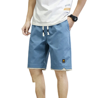 Man wearing loose straight-leg beach shorts in khaki, showcasing the South Korean style fit and micro-elastic waistband.