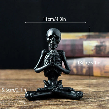 Spooky skeleton desktop decorations featuring intricate resin skulls and skeletons in vintage white and ominous black color options