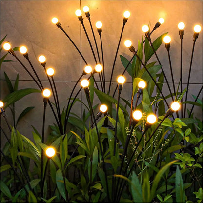 Solar-powered ground plug lawn light with automatic dusk-to-dawn operation and multiple head configurations