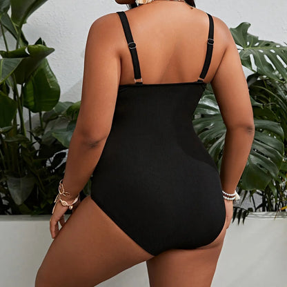 Black solid colour plus size one-piece swimsuit for women on a hanger.