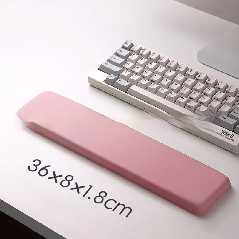 Square cloth mouse pad with grey silicone gel wrist rest and hand pillow on a wooden desk.