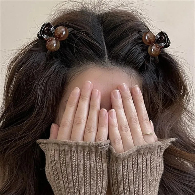 Pair of plastic hair barrettes with bow, leopard, bead and triangle styles for women's bangs