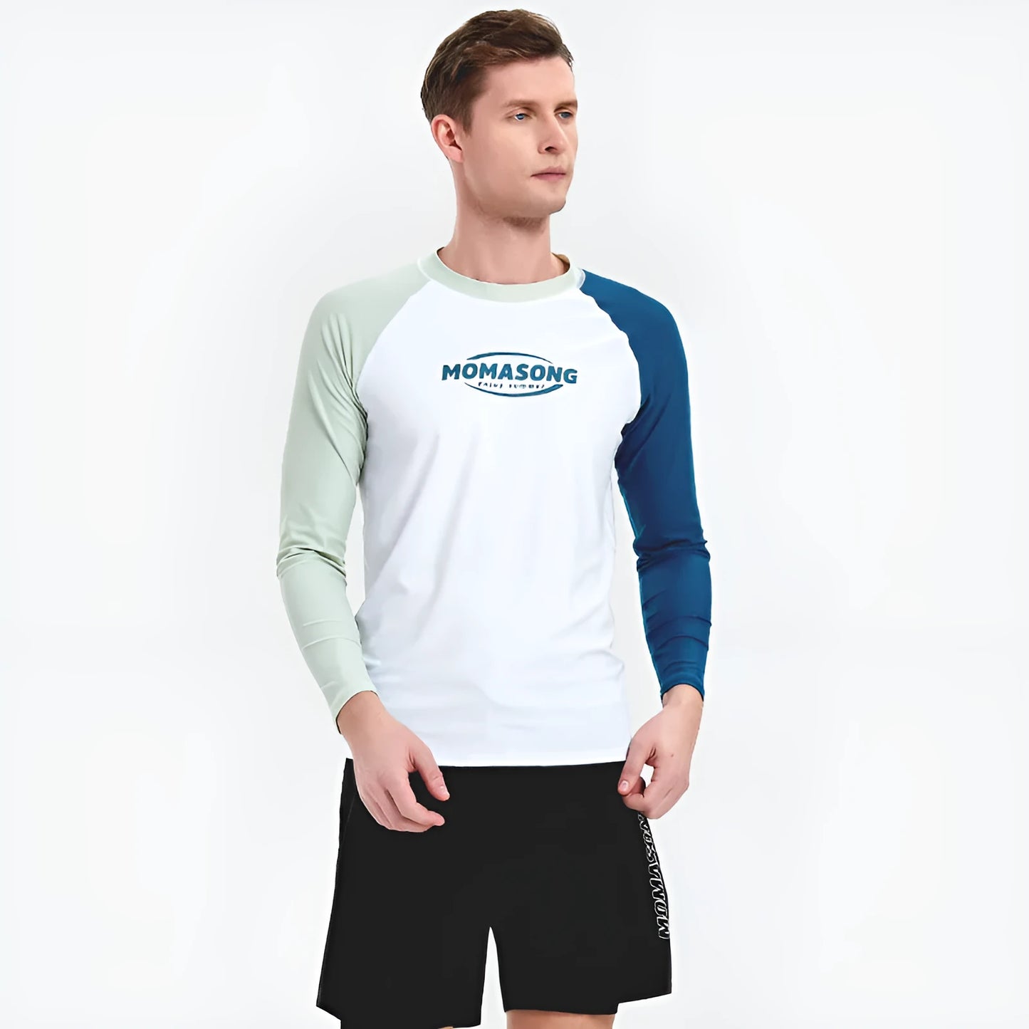 Man wearing a white long-sleeved swim top and matching blue swim trunks for sun protection during surfing.