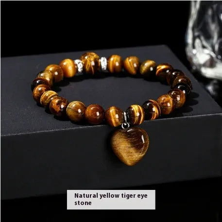 Handmade women's bracelet with natural gemstone beads and a silver love pendant charm.