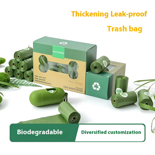 Roll of EPI green degradable pet waste bags next to a transparent dispenser on a grass background.