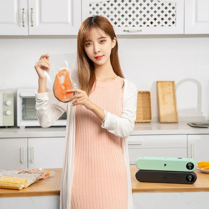 Green compact vacuum sealing machine, 32x7.5x5cm size, 110W power for food preservation with -50kPa pressure