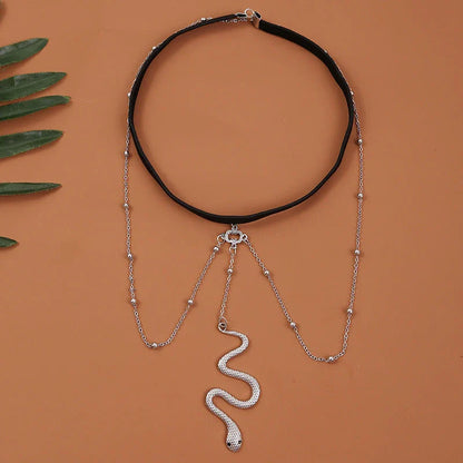 Glamorous Bohemian-style leg chain with snake pendant and metal beads, a unique and fashionable beach accessory