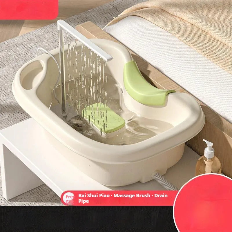 Portable plastic shampoo basin with neck pillow and water pump for bed hair washing.