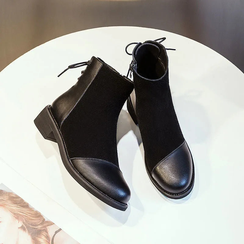 Women's black knee-length Martin boots with side zipper, non-slip rubber sole, and bow detail on microfiber upper