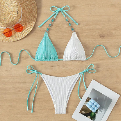 Colour-matched women's lace-up bikini with pearl chain detail on a sleeveless top and shorts.