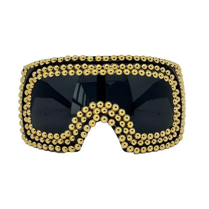 Square punk sunglasses with large rim and rivet detailing in gold colour