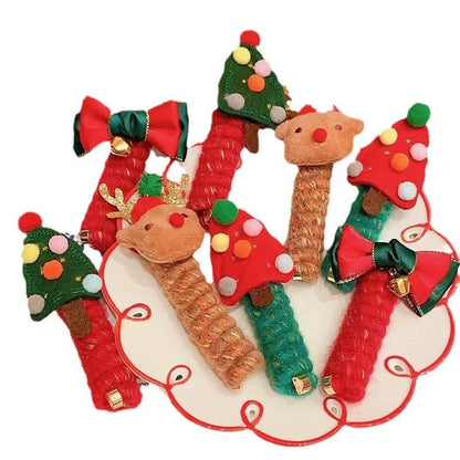 Festive Christmas hair ties with various holiday-themed designs, including red bells, green Christmas trees, and khaki deer shapes.