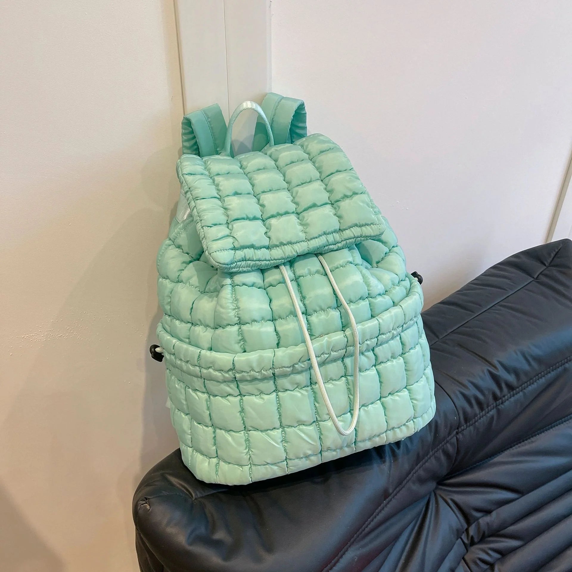 Soft, quilted puffer backpack in a variety of colors, perfect for autumn and winter wear