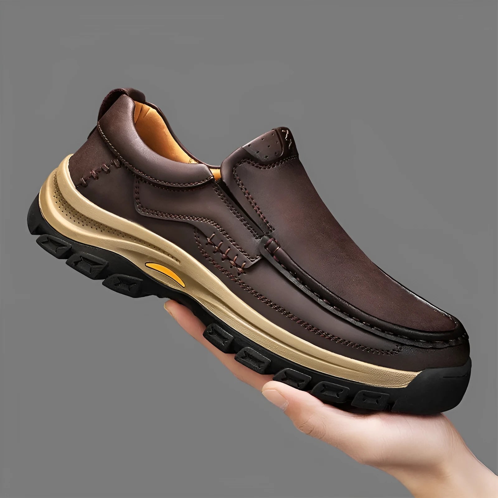 Men's black leather mountaineering shoes with thick rubber sole and round toe.