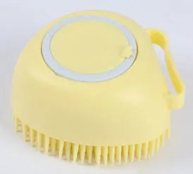 Blue silicone dog bath and massage brush held in a hand.