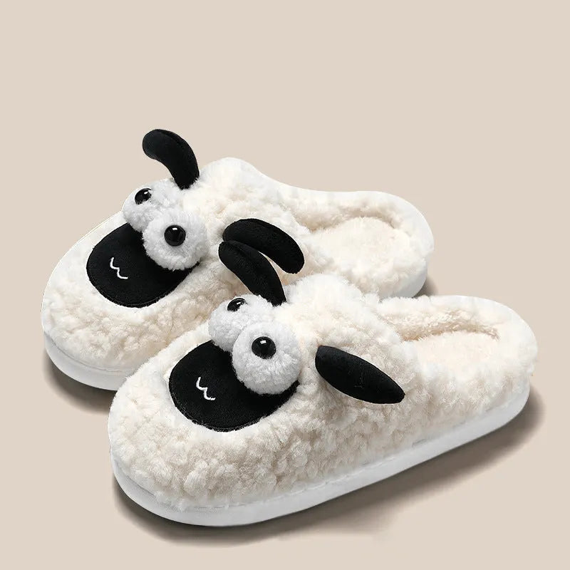 Brown suede slip-on slippers with thermal cotton body and sewn PVC sole on a wooden floor.