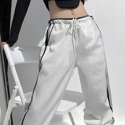 Women's loose straight leg trousers with ribbon parallel bars contrast colour detail on low waist, in thin fabric.